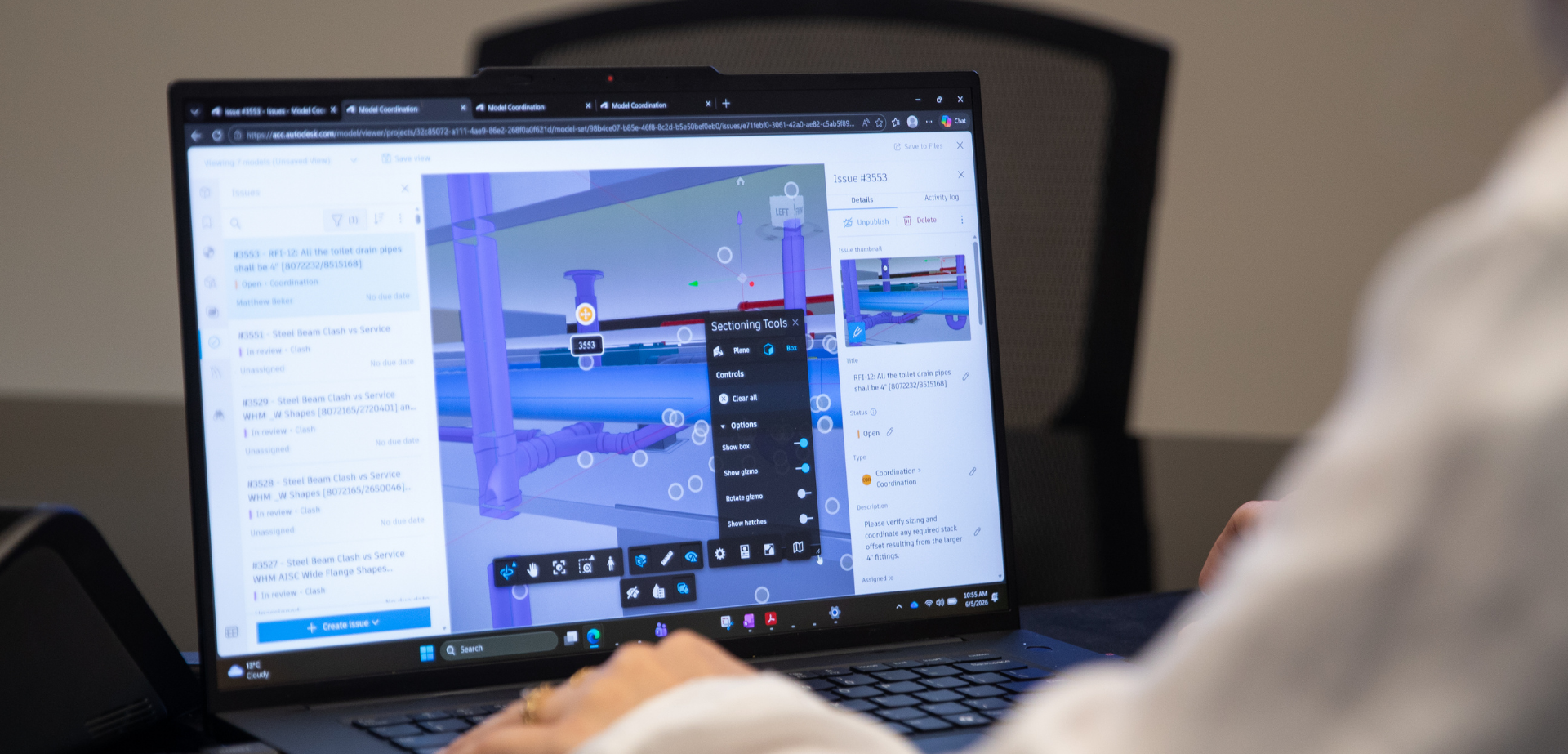 BIM team member reviewing a 3D building model and identifying coordination issues between structural and mechanical systems using BIM software.